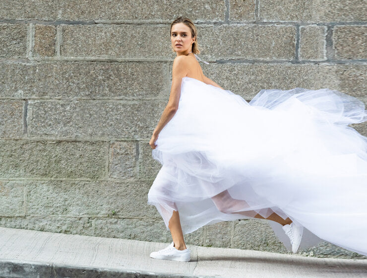 A model running in a Christina Devine dress