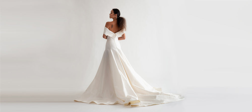 A model wearing a Christina Devine wedding gown