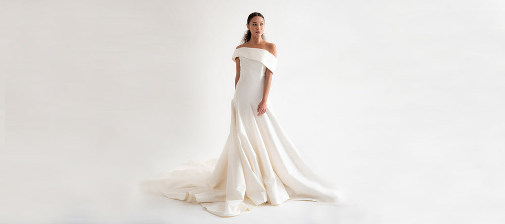 A model wearing a Christina Devine wedding gown
