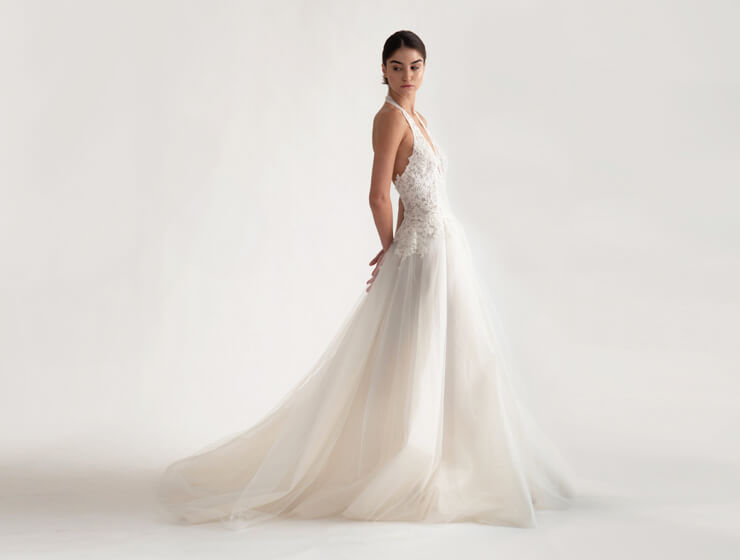 A model wearing a Christina Devine wedding dress